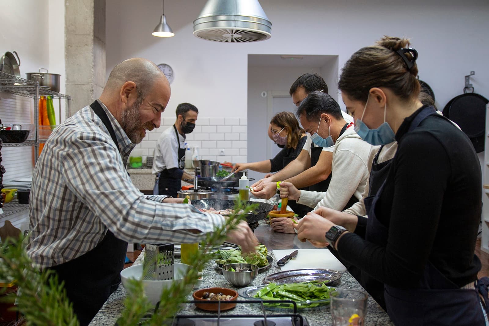 Hands-on paella workshop with participants prepping ingredients