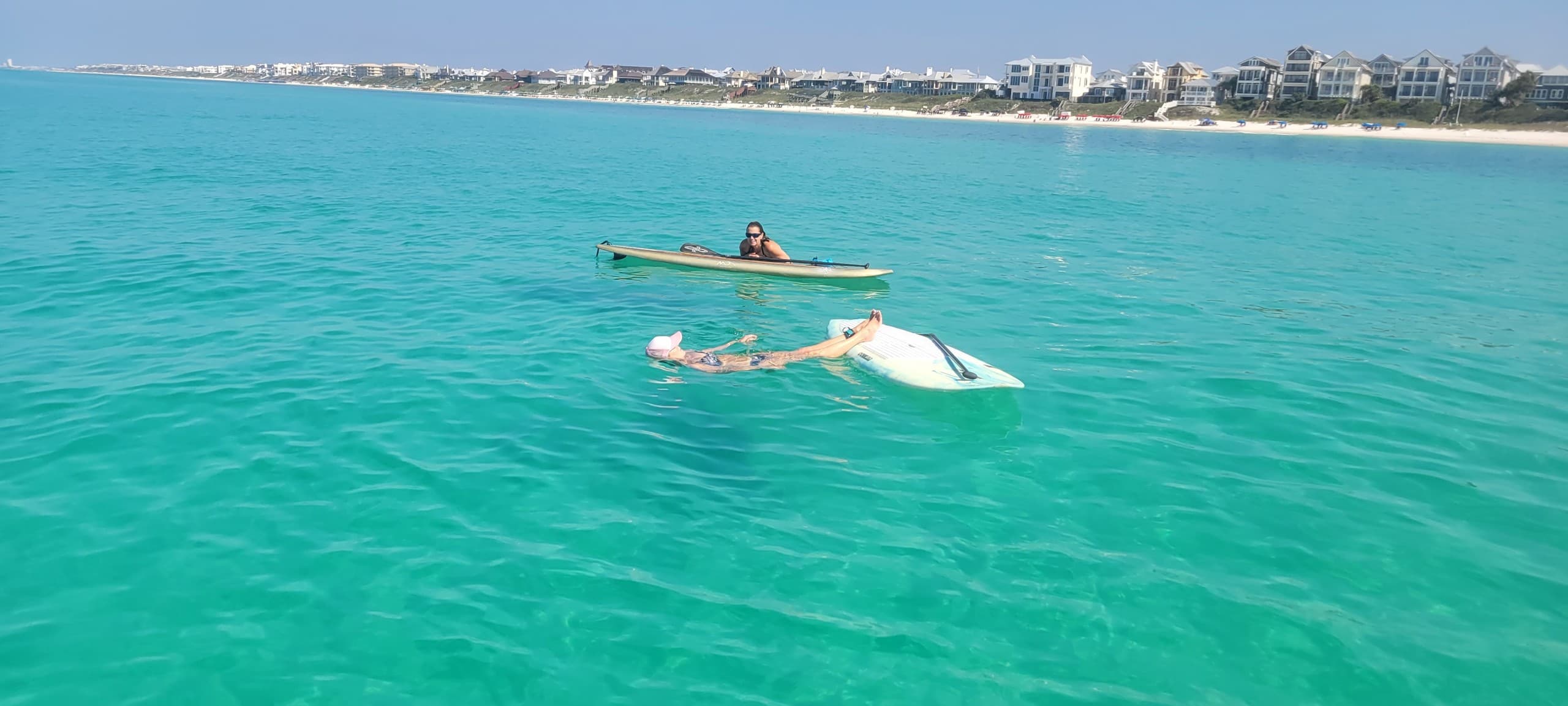 Relaxing paddlers floating on bright turquoise Gulf waters