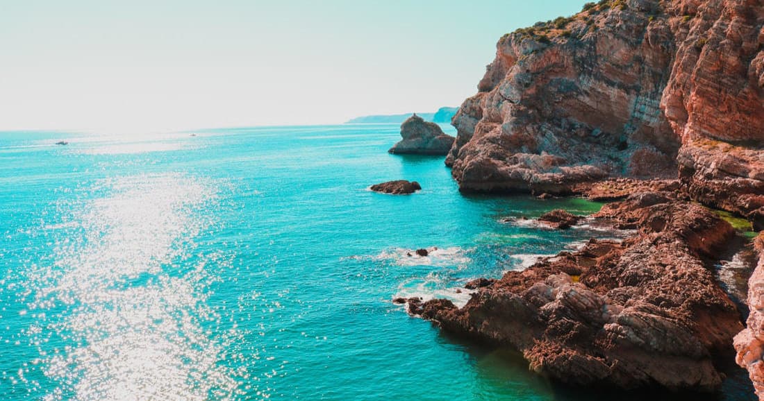 Rocky coastline and turquoise sea ideal for coastal hiking views