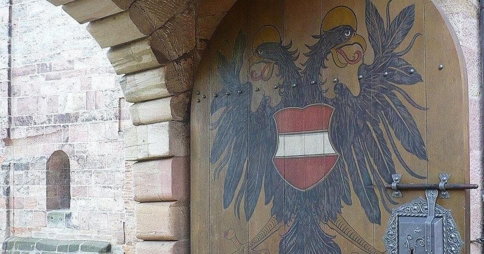 Decorated wooden gate with imperial eagle crest at Nuremberg castle entrance