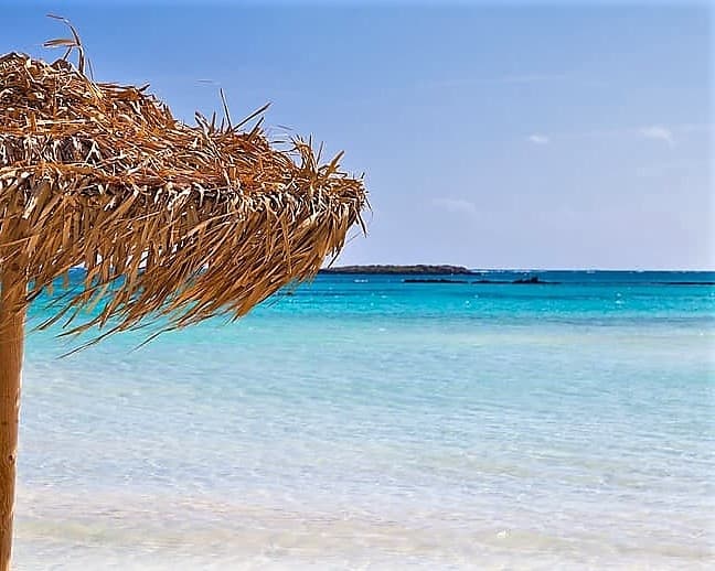 Tropical beach with palapa umbrella on turquoise Baja shore