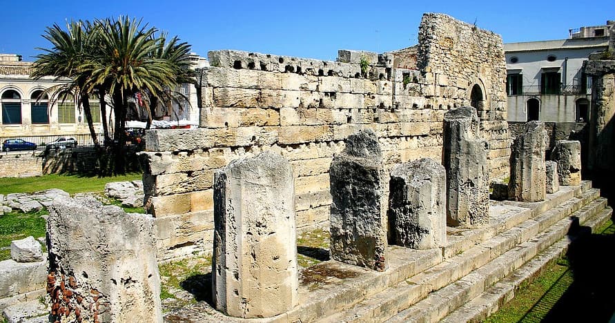 Walking among coastal Roman ruins and palm trees in Sicily
