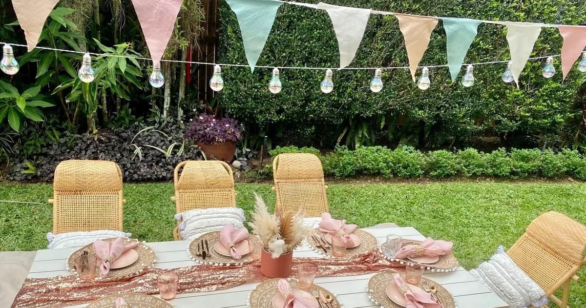 Outdoor garden picnic table with bunting and string lights