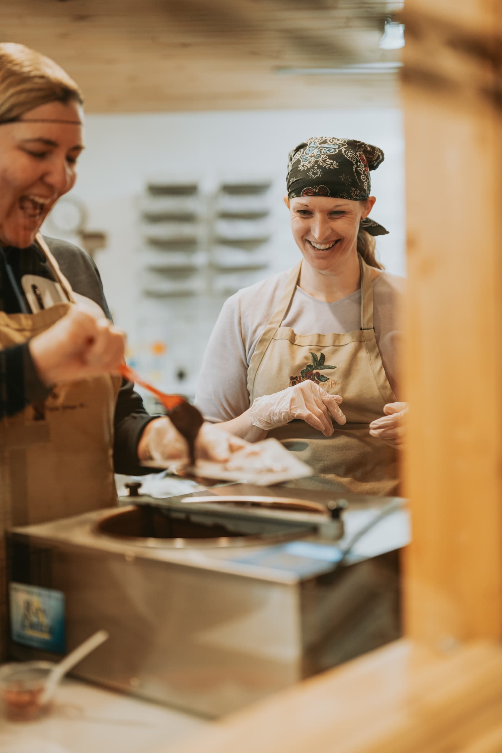 Chefs preparing food at indoor market stall, hands-on cooking