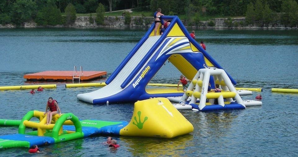 Guests climbing inflatable slide at Sheboygan quarry water park
