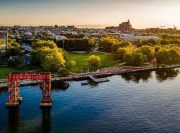 City riverfront at sunset with waterfront pier and skyline