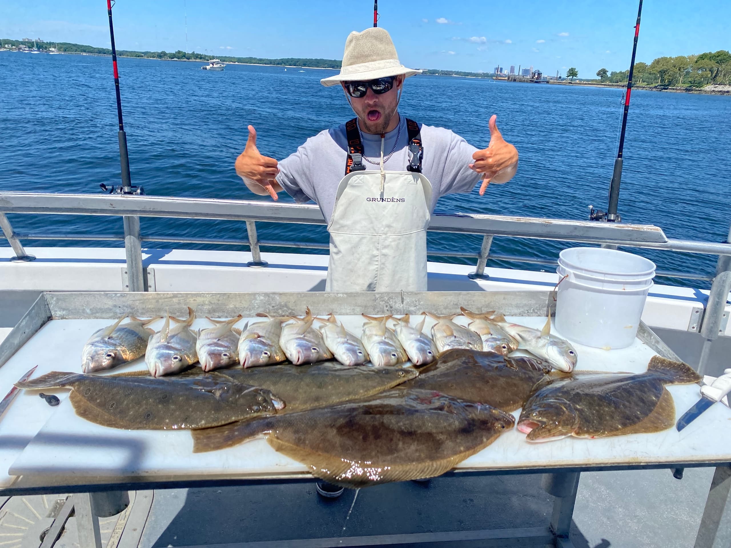 Captain displaying mixed catch on deck after full day fishing trip