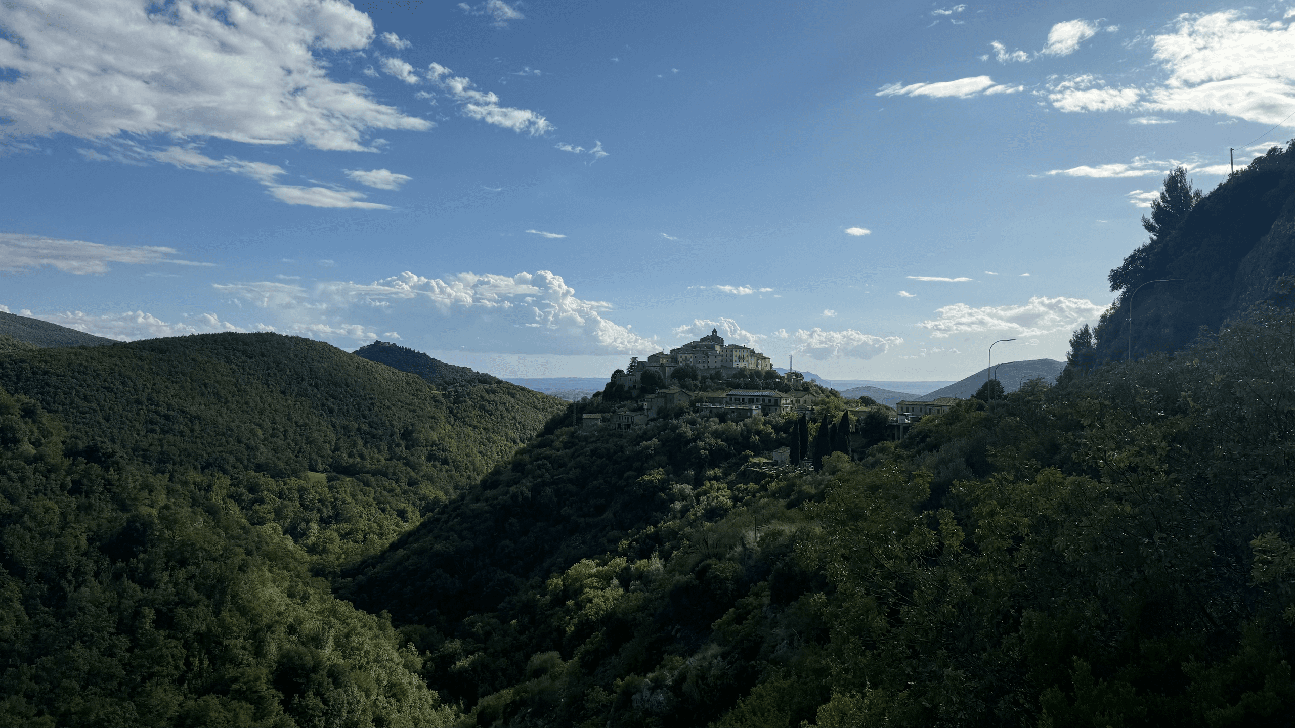 Valley village panorama with ridgelines, scenic cycling route