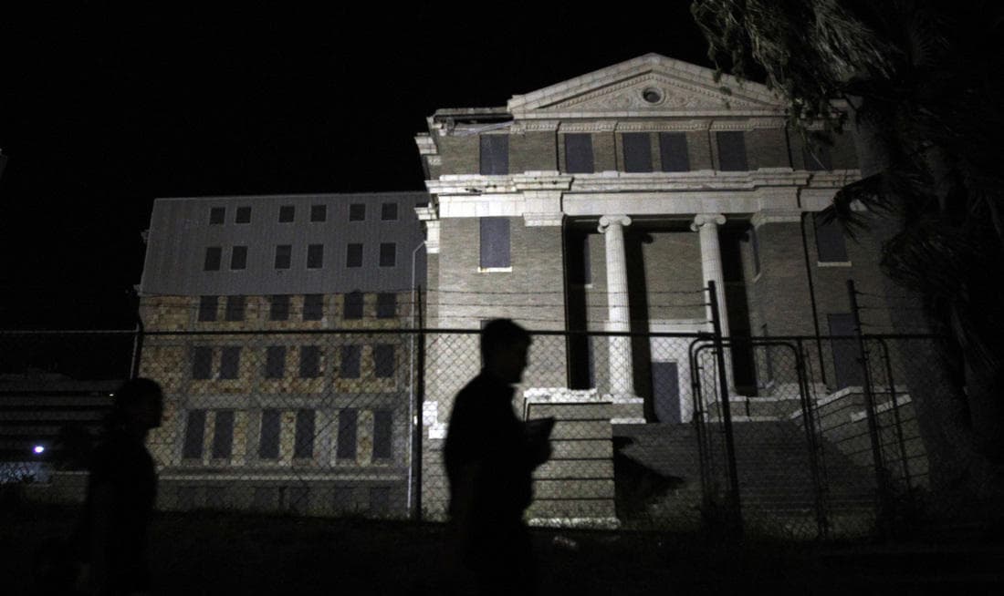 Silhouetted courthouse steps at night, haunted history walking tour