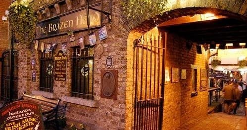 Historic Dublin pub exterior at night, traditional pub entrance