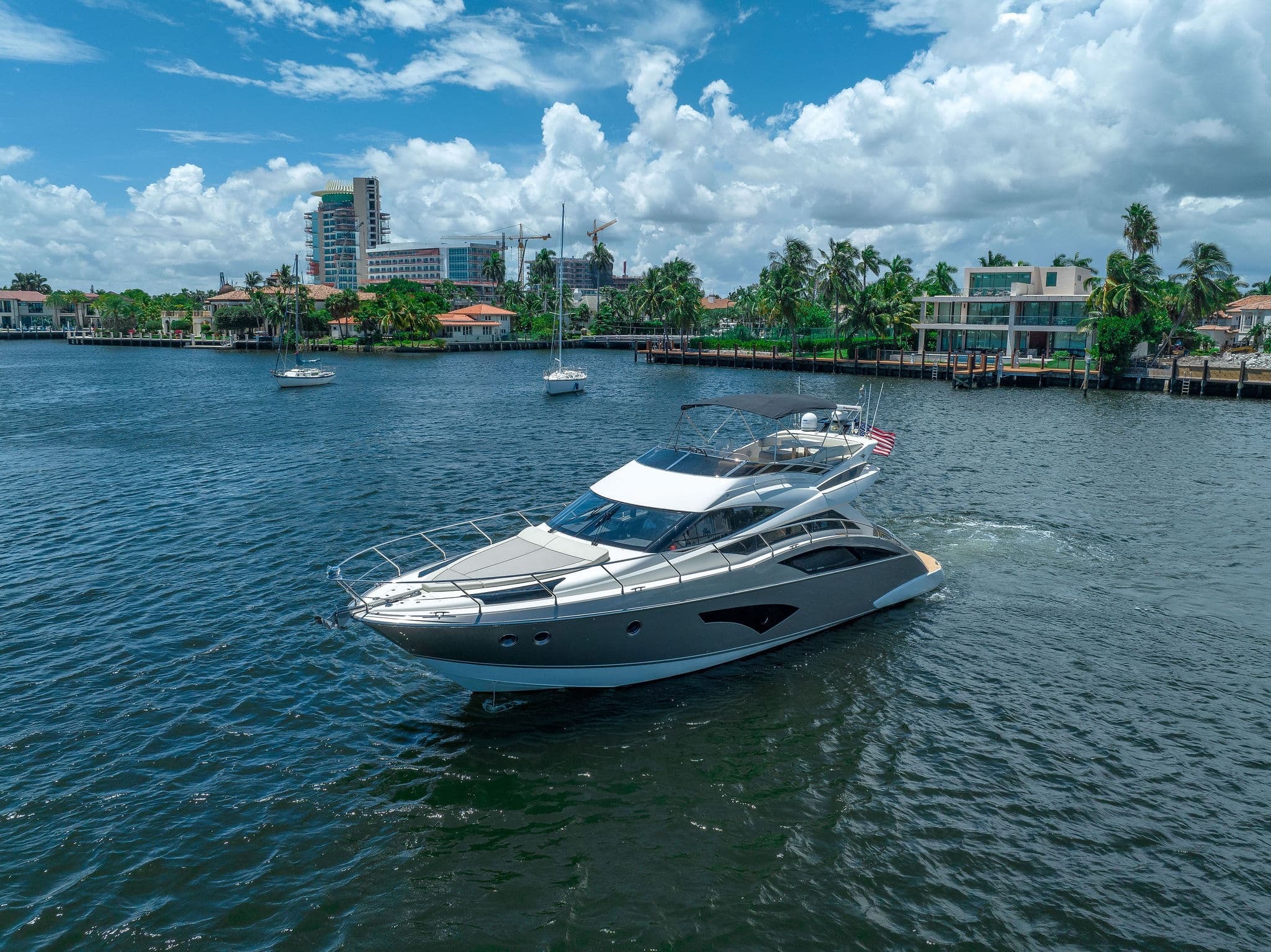 Motor yacht cruising coastal waters off Florida marina