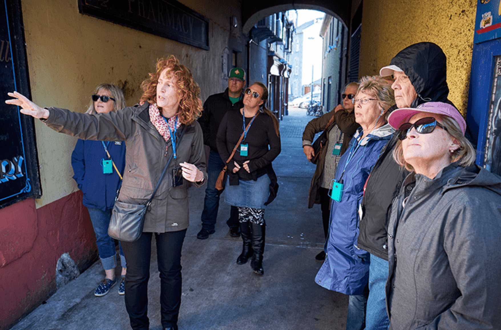 Guide leading walking tour through scenic narrow Irish street