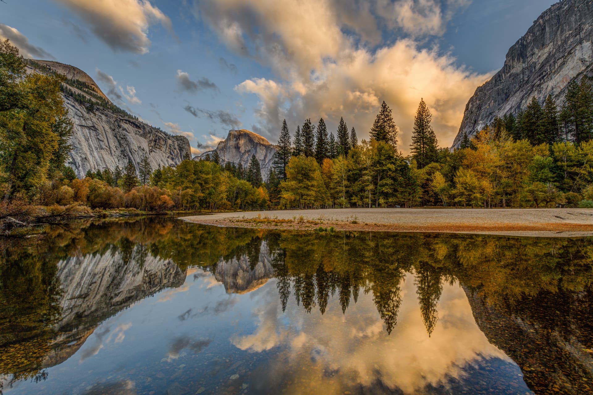 Scenic mountain valley landscape with river reflection at sunset