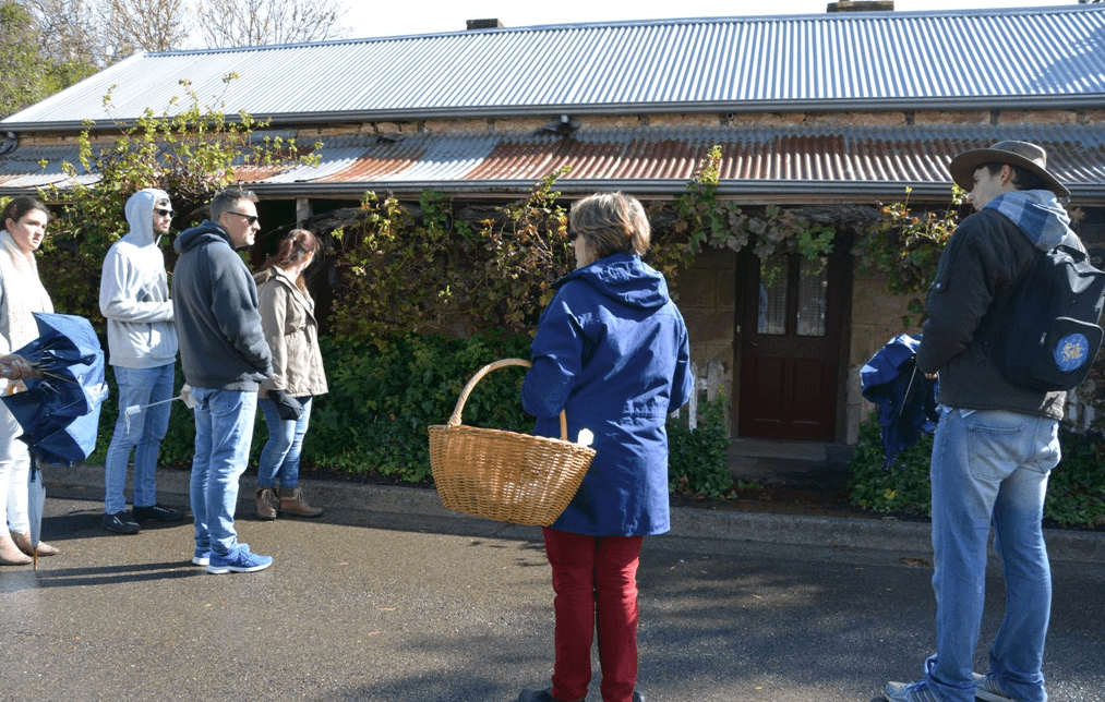Guided walking tour group outside historic Hahndorf buildings