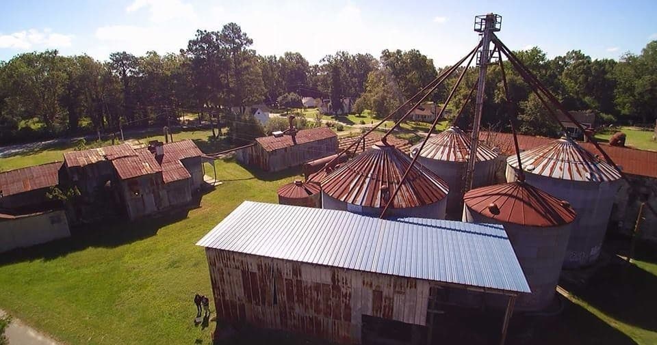 Aerial view of rusted grain silos at rural Haralson mill