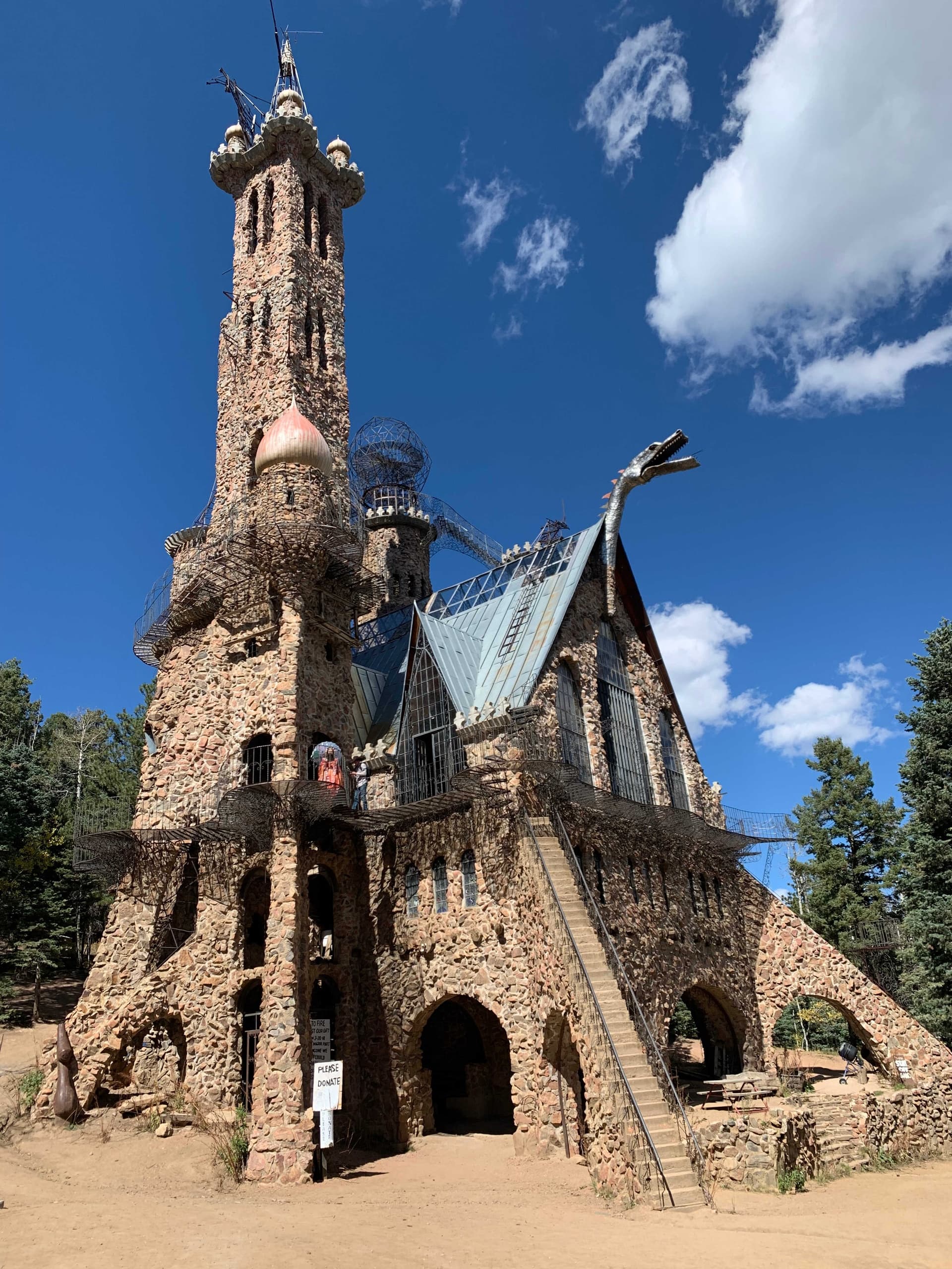 Rustic stone castle attraction amid forest, historic outdoor sightseeing
