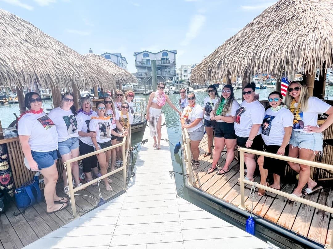 Group of friends boarding tiki boat at sunny South Jersey dock