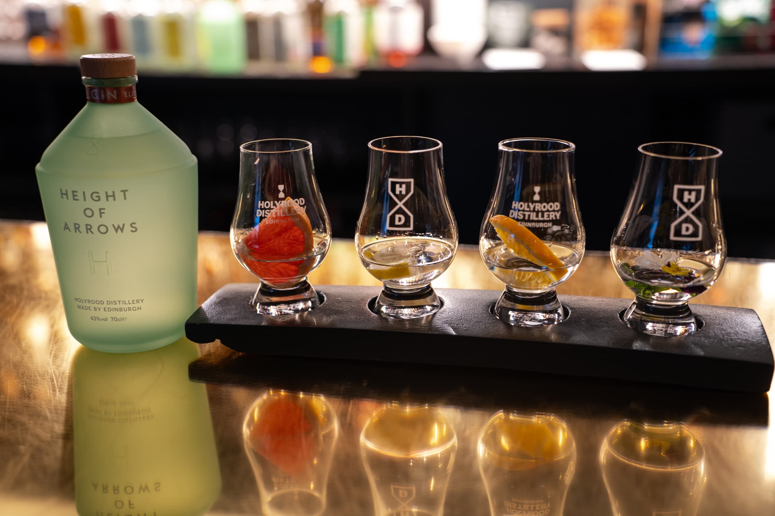 Whisky flight and bottle on bar at Holyrood Distillery tasting