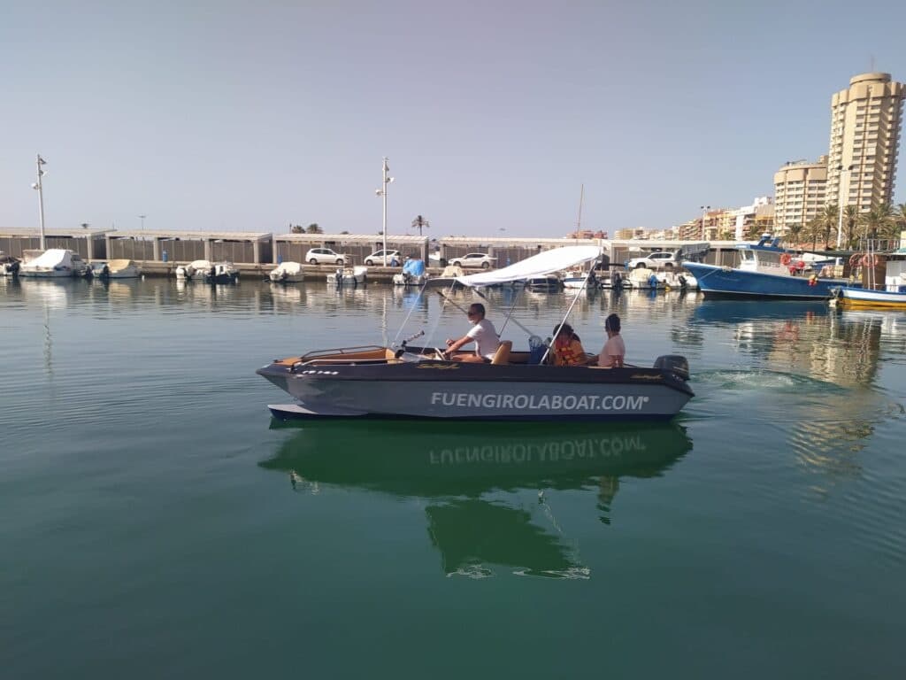 Small leisure boat docked in Fuengirola marina, calm waters