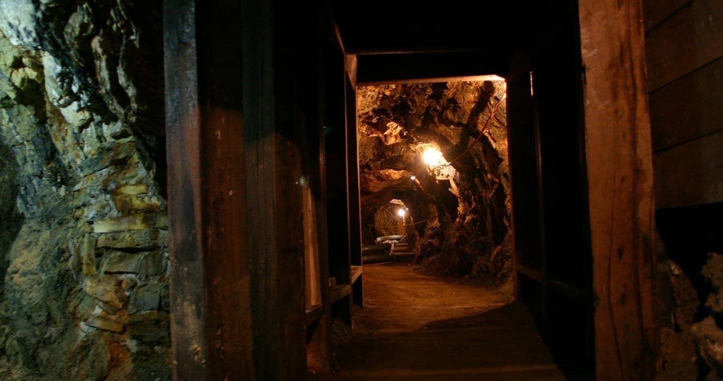Dimly lit historic mine tunnel interior for underground exploration