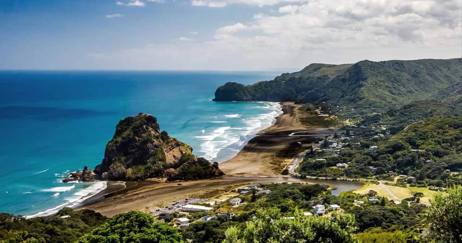 Scenic coastal headland and sandy beach for surfing and hiking