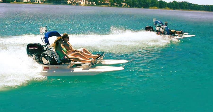 Jet ski riders racing across turquoise coastal waters, high speed