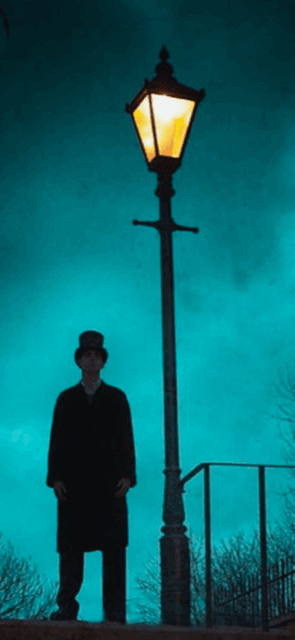 Nighttime lamplight ghost walking tour under streetlamp