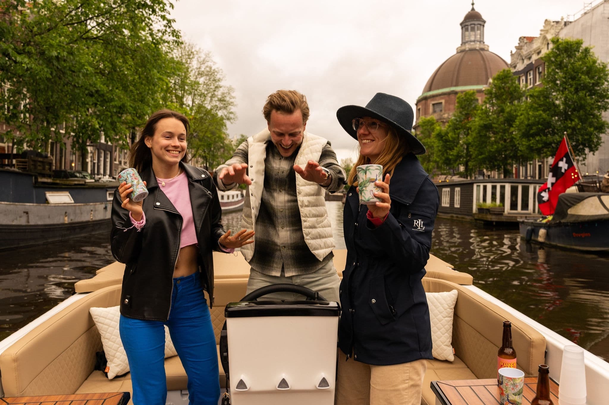 Friends enjoying a lively canal boat tour through Amsterdam