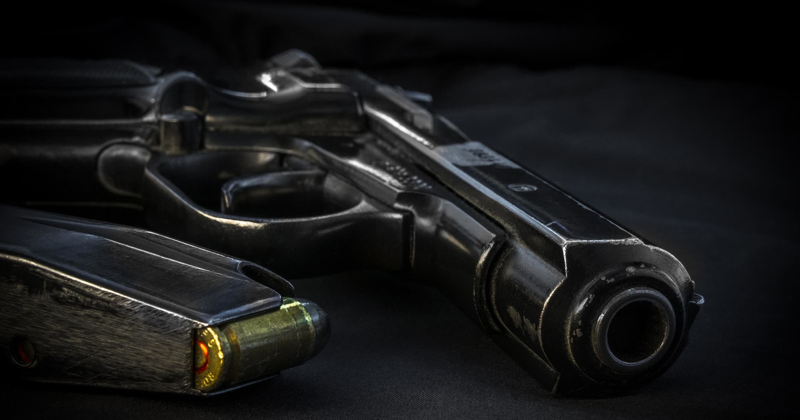 Close-up handgun on dark cloth at shooting range, tactical display