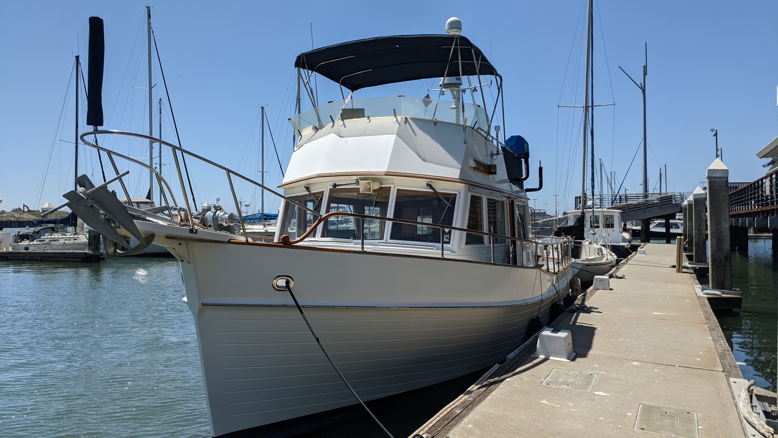 Pleasure yacht docked at marina pier ready for harbor cruise