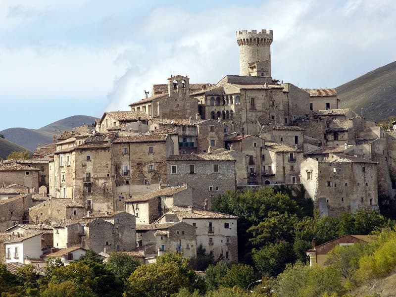 Hilltop medieval village overlooking wooded valley and terraces