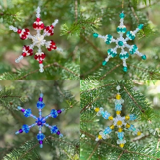 Beaded snowflake ornaments hanging on evergreen outdoors