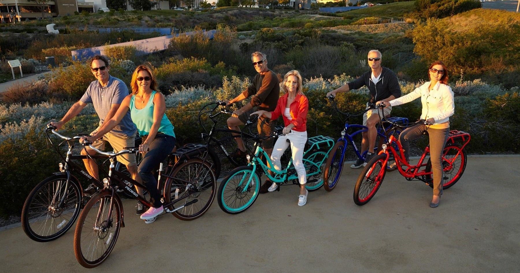Group of riders on colorful bikes enjoying scenic sunset ride