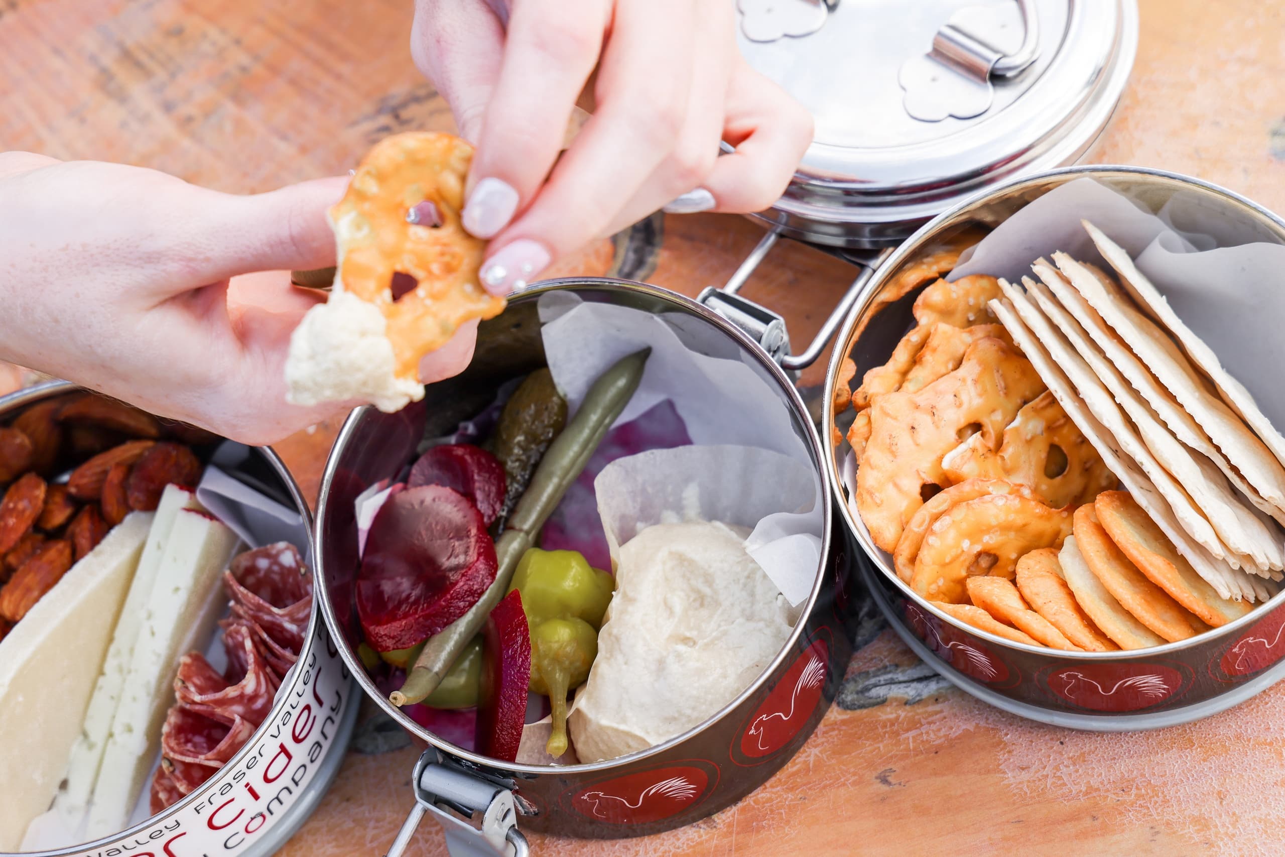 Outdoor picnic charcuterie and crackers on wooden table