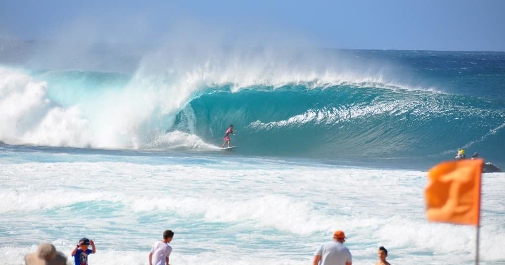 Big ocean wave breaking at Hawaii beach, surfing action