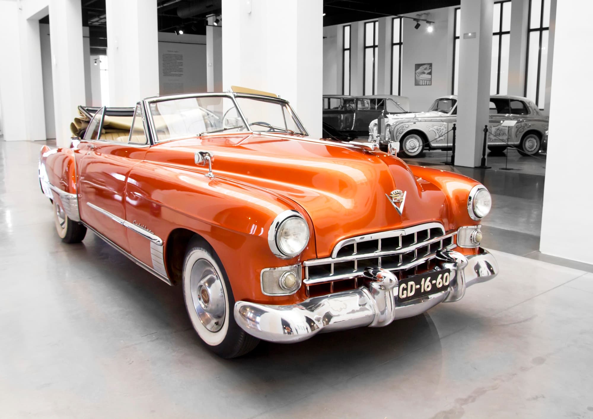 Orange classic convertible exhibited inside Museo Automóvil Málaga gallery