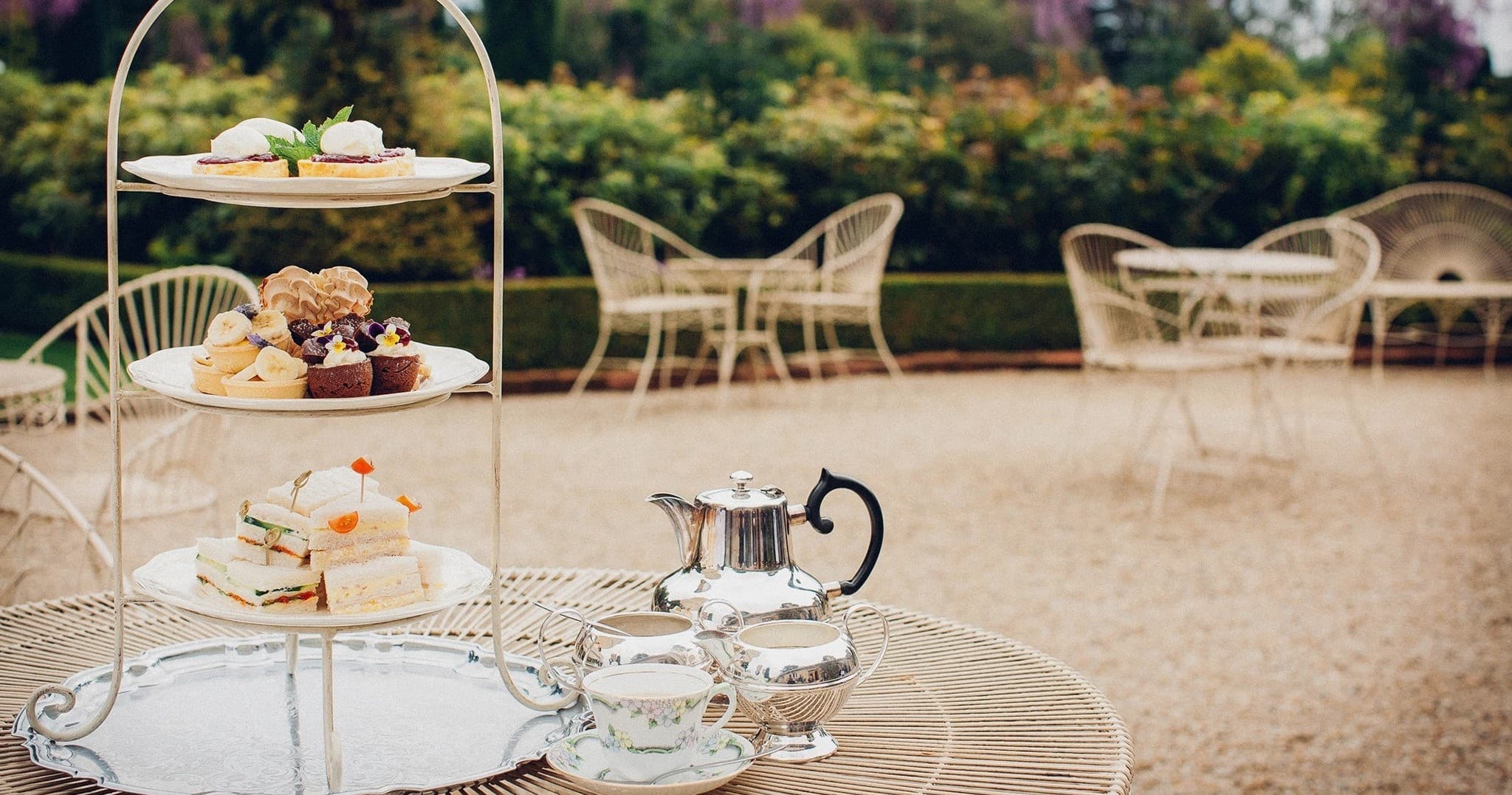 Afternoon tea setup on terrace overlooking Larnach Castle gardens
