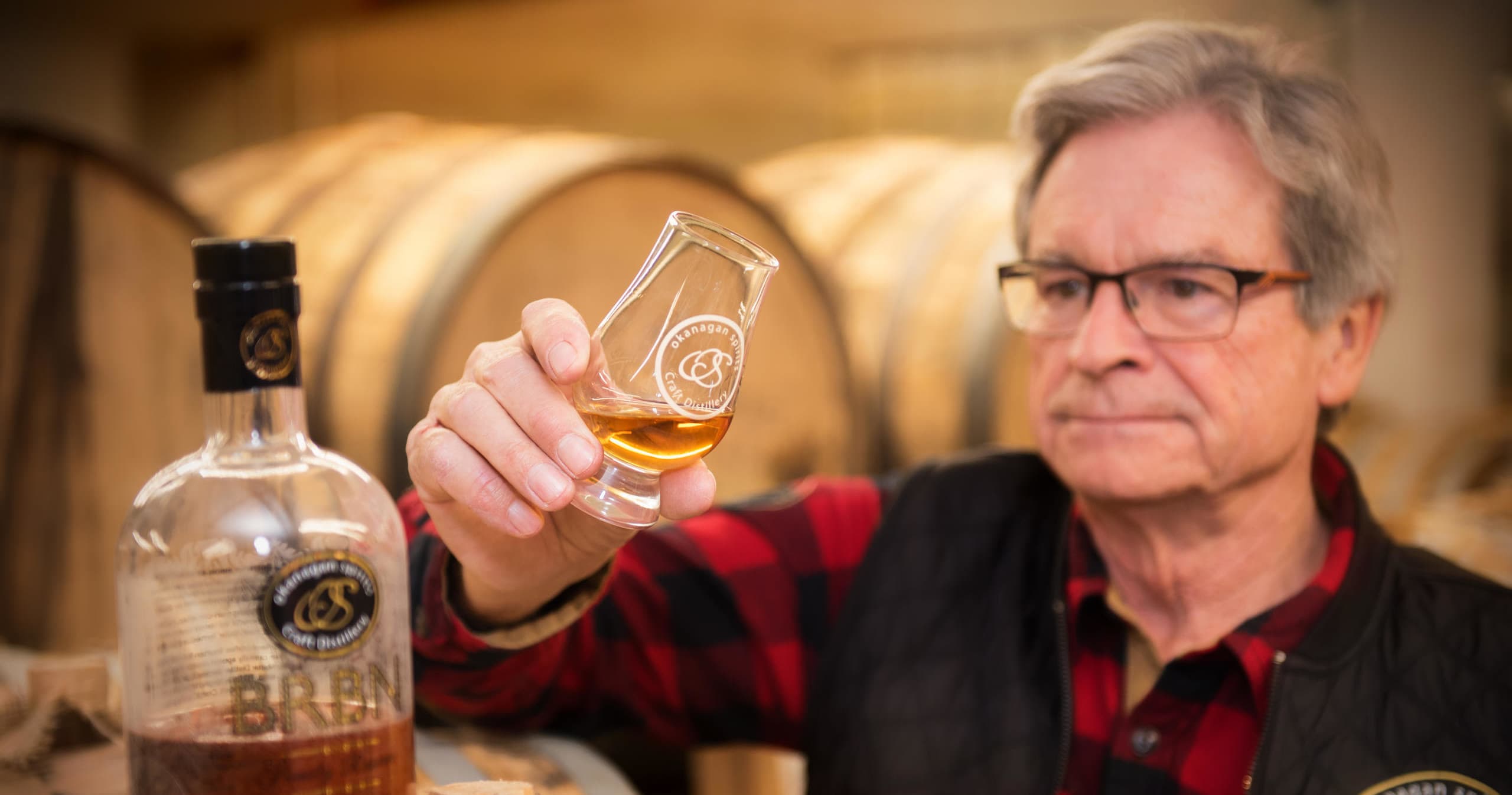Master distiller sampling whiskey in Okanagan barrel room