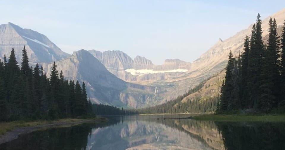 Mountain lake reflecting peaks, alpine scenery for hiking tours