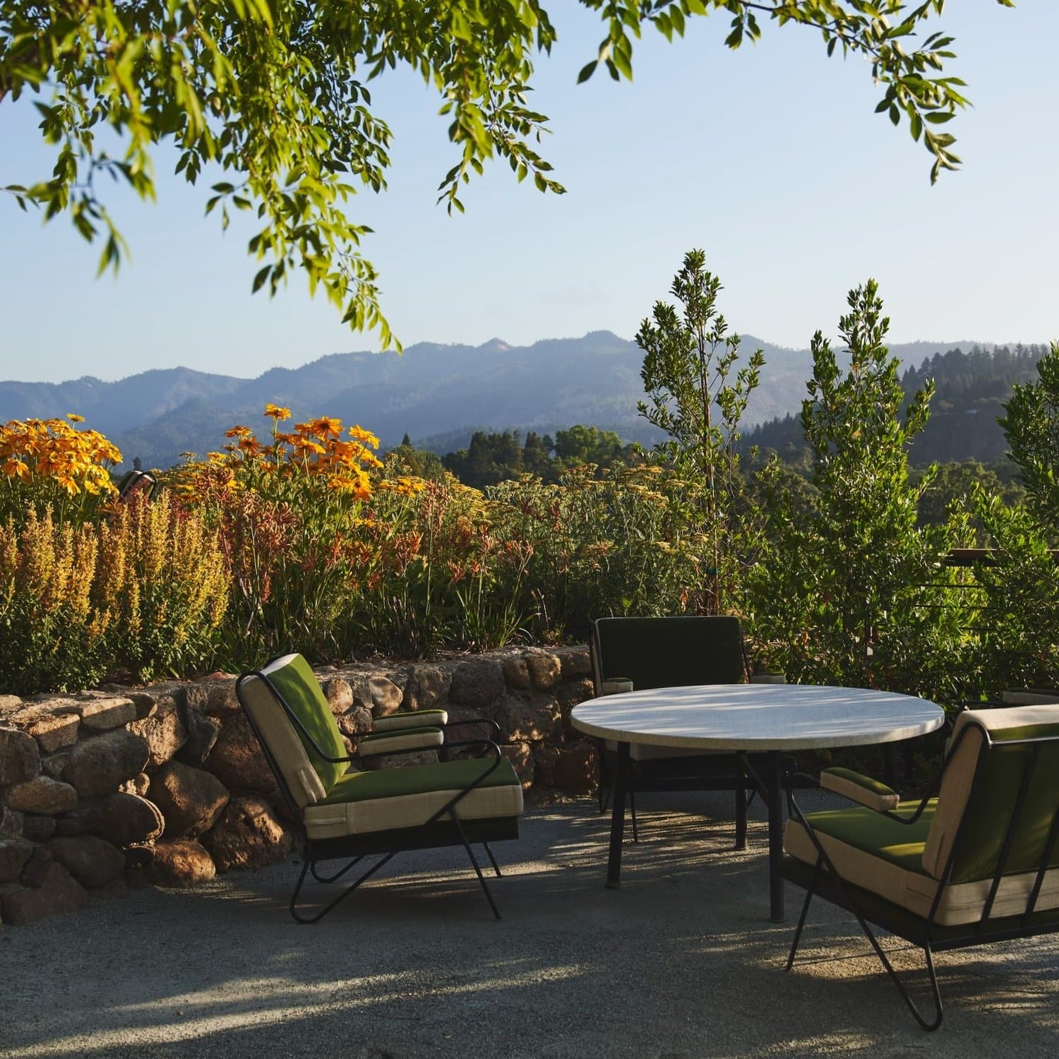 Outdoor patio with table overlooking mountain valley scenery