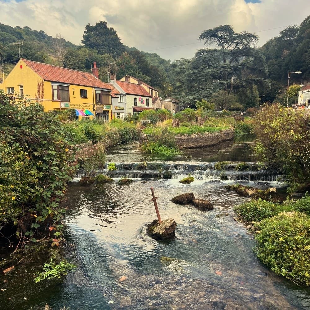 Cottages by a shallow river with cascades, ideal for village walks