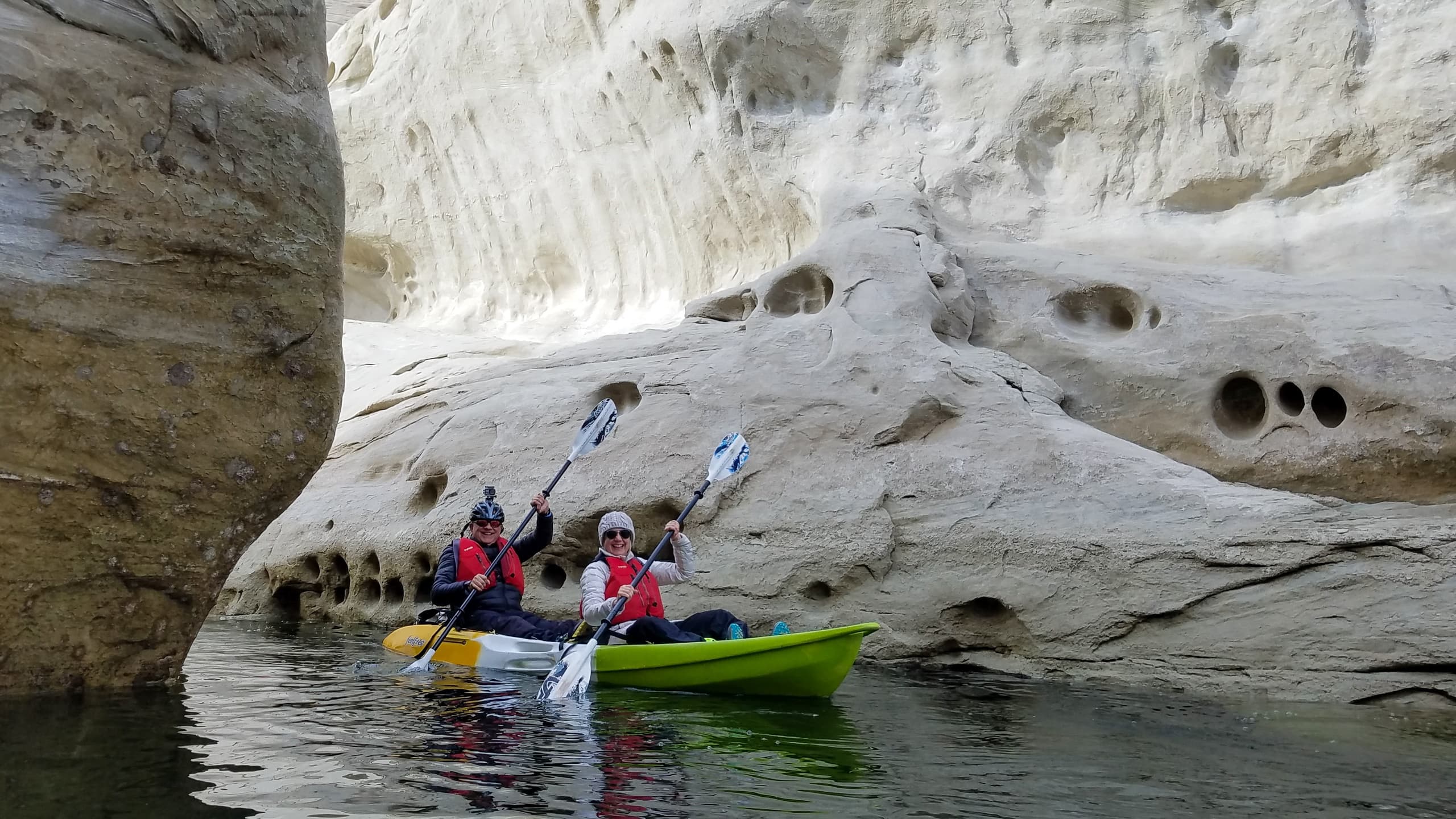 Kayakers navigating narrow sandstone canyon on Lake Powell