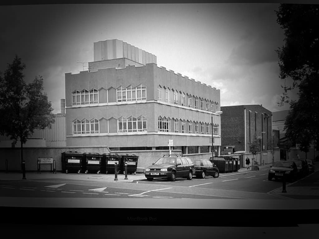 Monochrome civic building on city corner, classic urban architecture