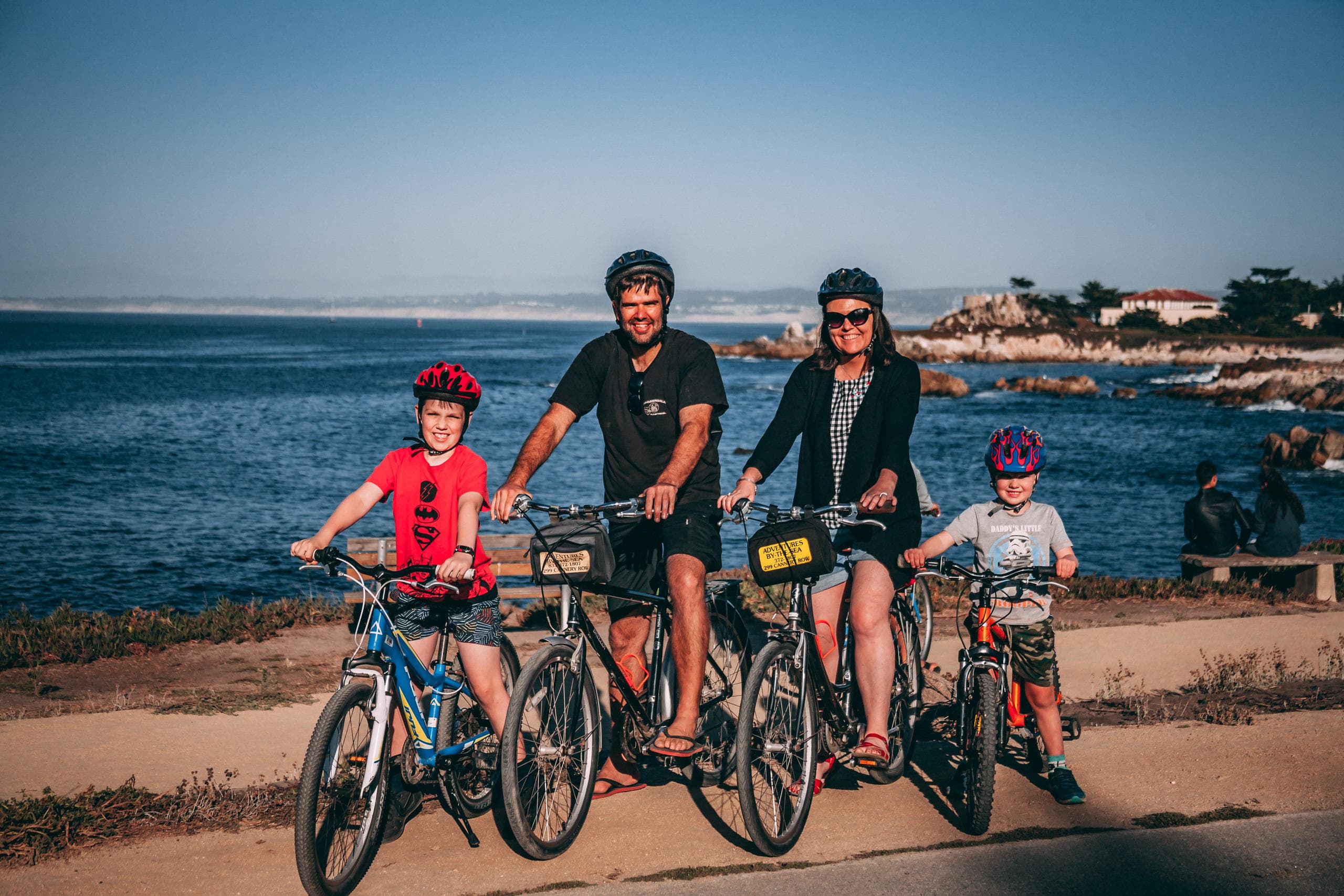 Family bike ride along seaside path near beach