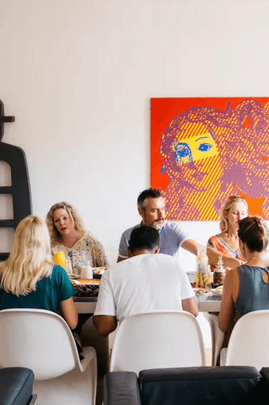 Friends sharing a communal meal in modern indoor dining room