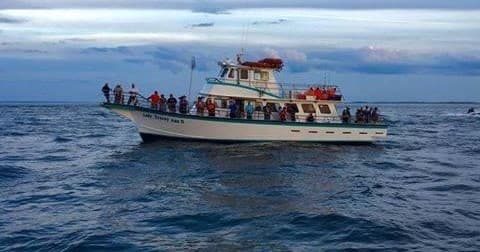 Passenger fishing charter boat cruising offshore with anglers aboard