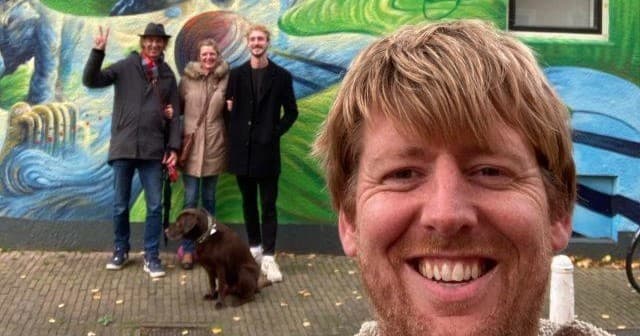 Walking tour group with guide by colorful mural in Leeuwarden