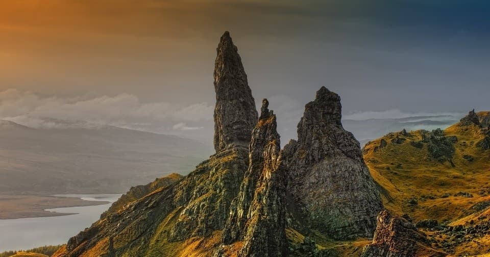 Sunset hike past jagged sea stacks on Isle of Skye ridge