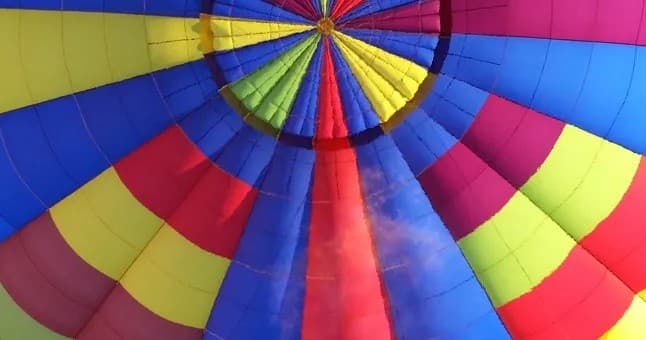 Colorful hot air balloon canopy viewed from inside during preflight