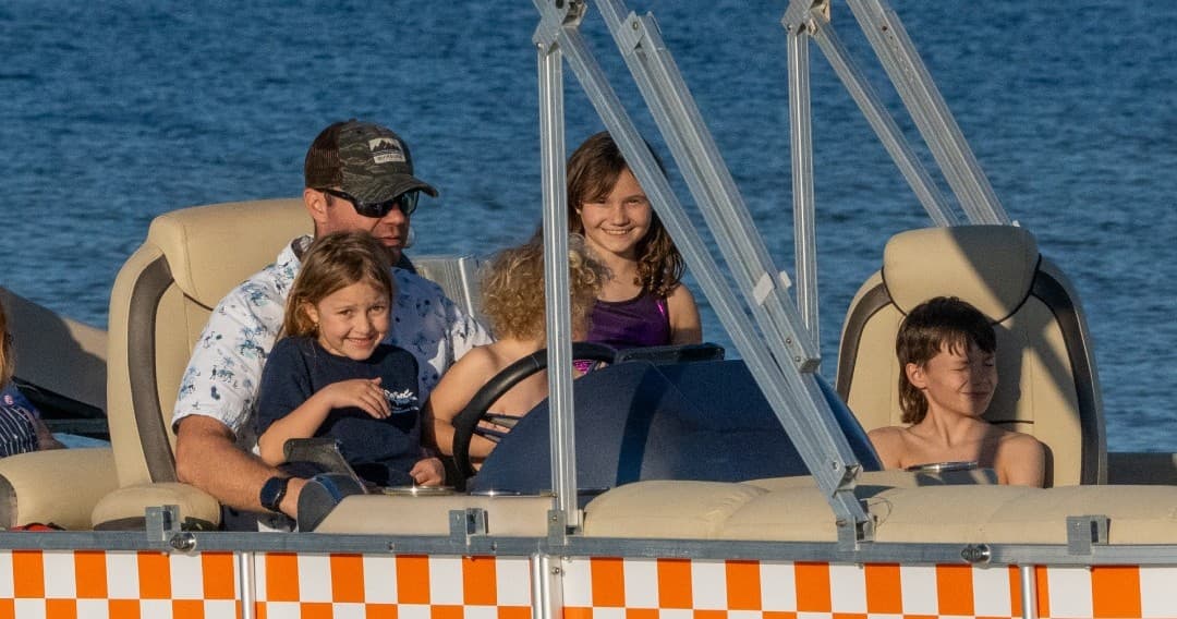 Family enjoying pontoon cruise on Pensacola Bay